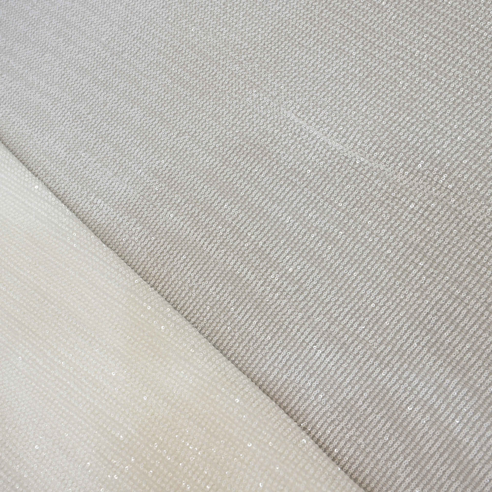 Close-up of two textured fabric samples, one beige and one gray.