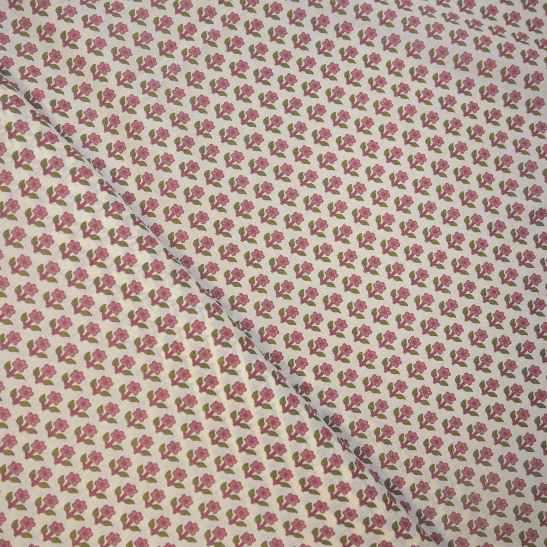 Floral cotton fabric with small pink flowers on a light background