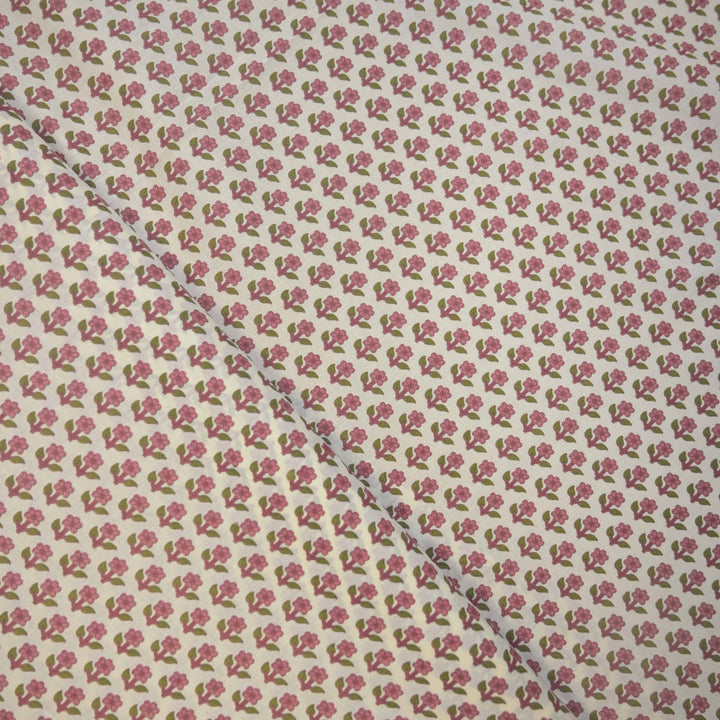 Floral cotton fabric with small pink flowers on a light background