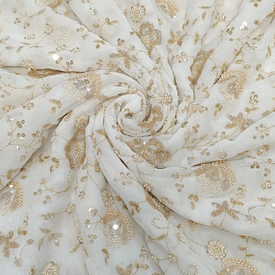 White fabric with gold floral embroidery and sequins
