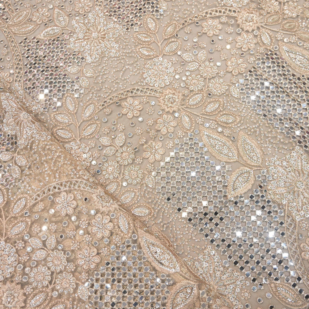 Decorative fabric with intricate paisley pattern and sequins in beige and silver.