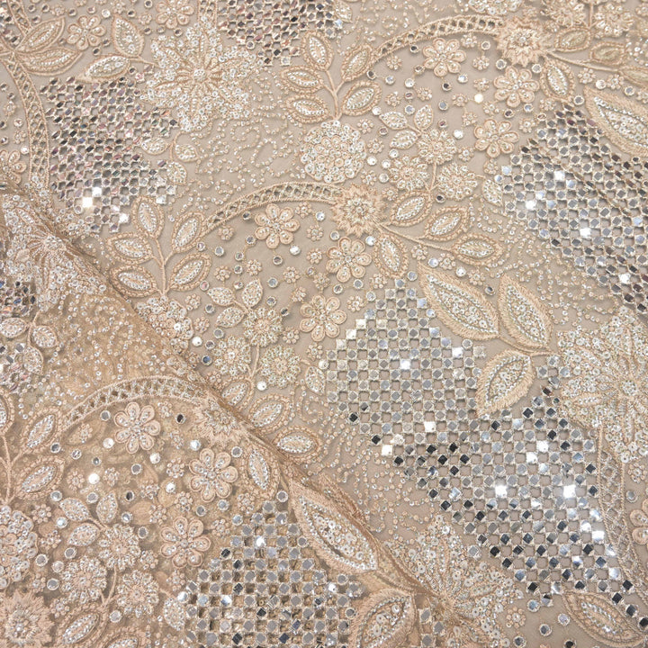 Decorative fabric with intricate paisley pattern and sequins in beige and silver.