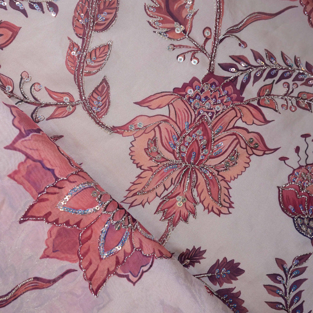 Organza floral fabric with pink and purple flowers and decorative elements.