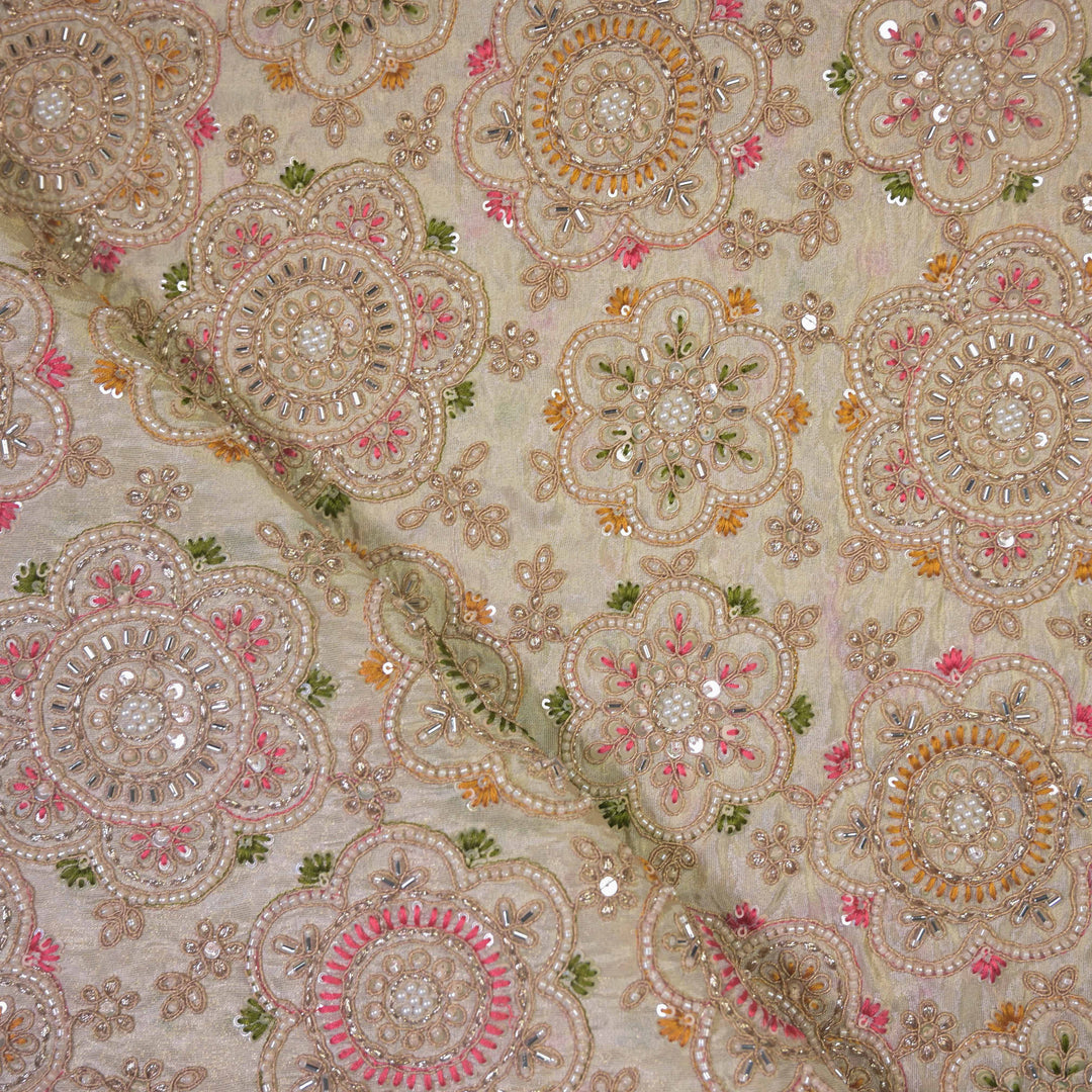 Decorative fabric with intricate patterns and embellishments on a beige Fabric