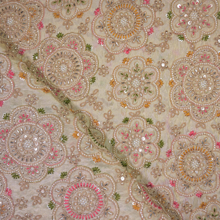 Decorative fabric with intricate patterns and embellishments on a beige Fabric