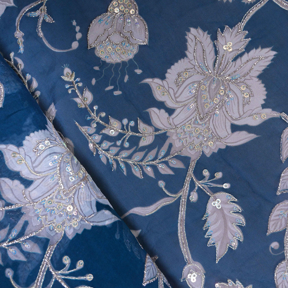 Embroidered fabric with floral patterns on a blue background