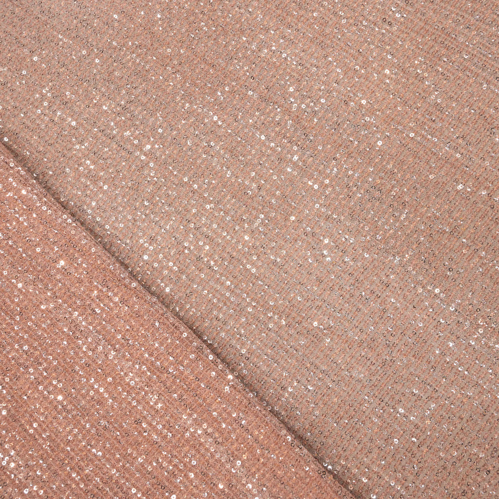 Close-up of a folded piece of rose gold glittery fabric.