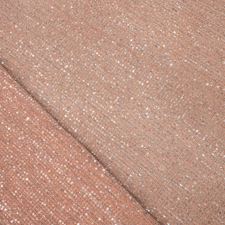 Close-up of a folded piece of rose gold glittery fabric.