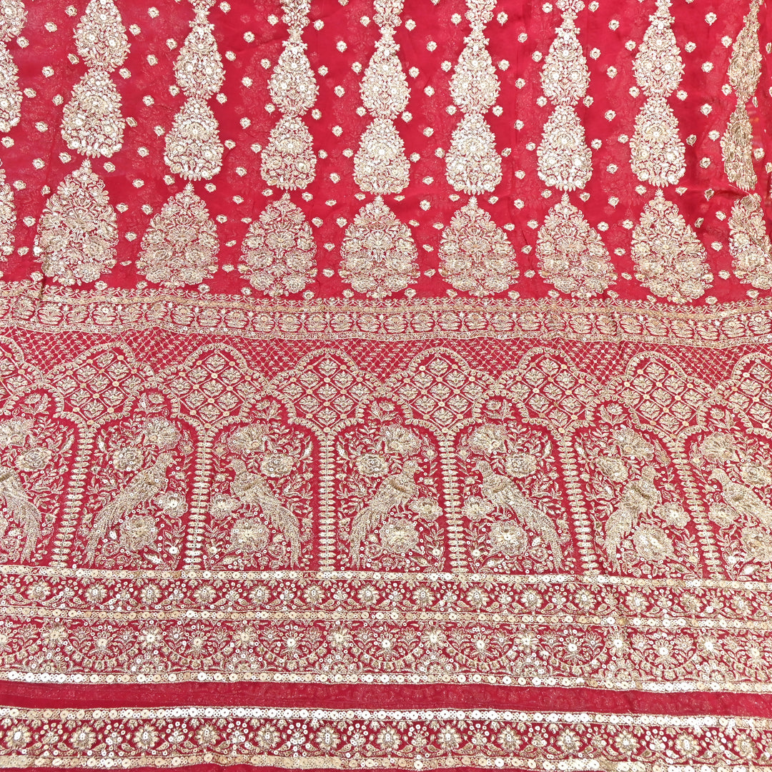 Decorative fabric with intricate gold patterns on a red background